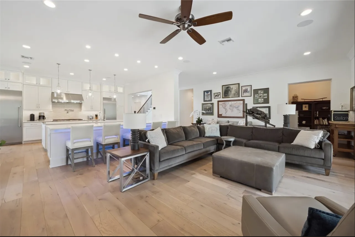 Great room open to the kitchen with wide-plank wood floors