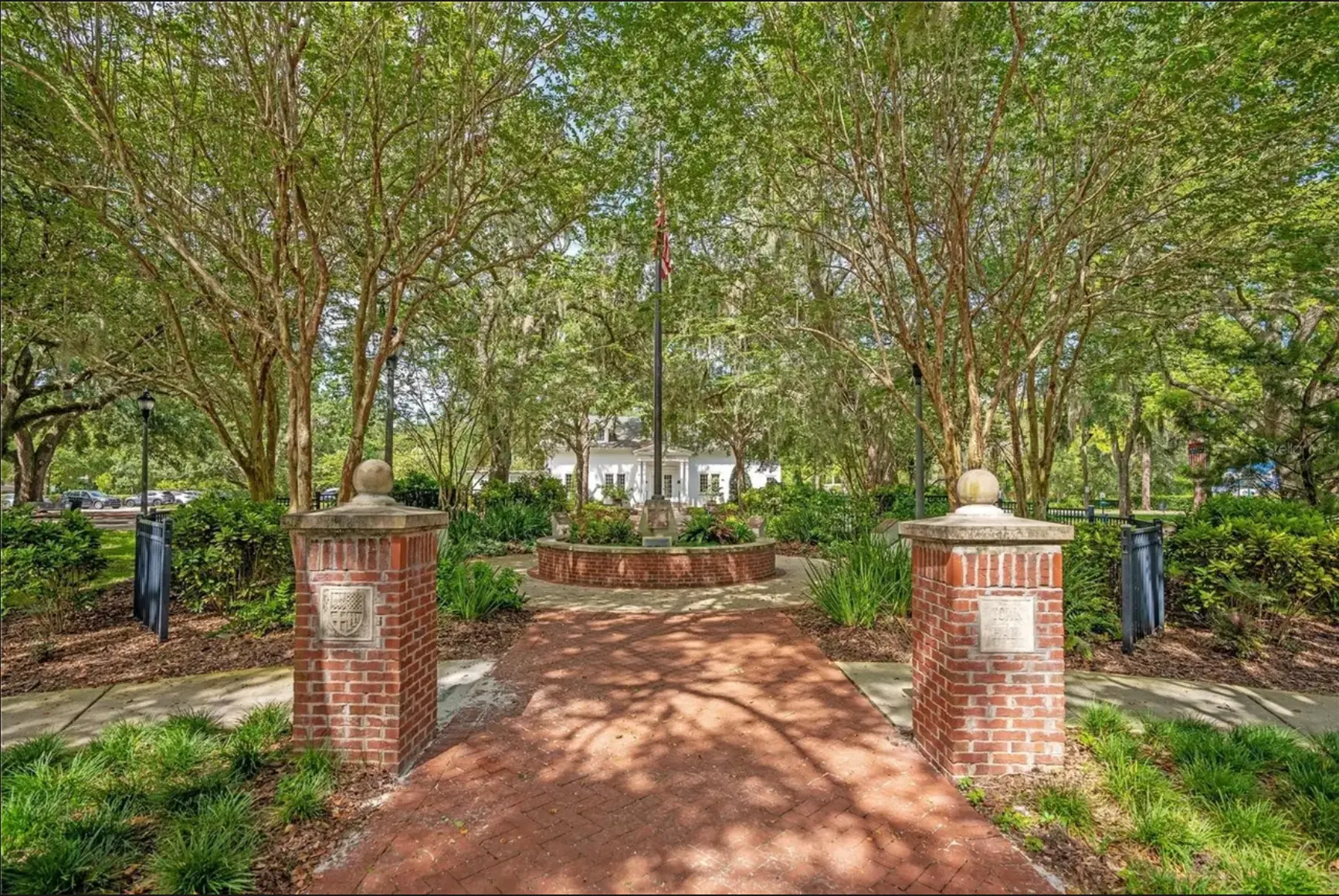 Brick pillar entrance and shaded walkway leading into Windermere Town Square