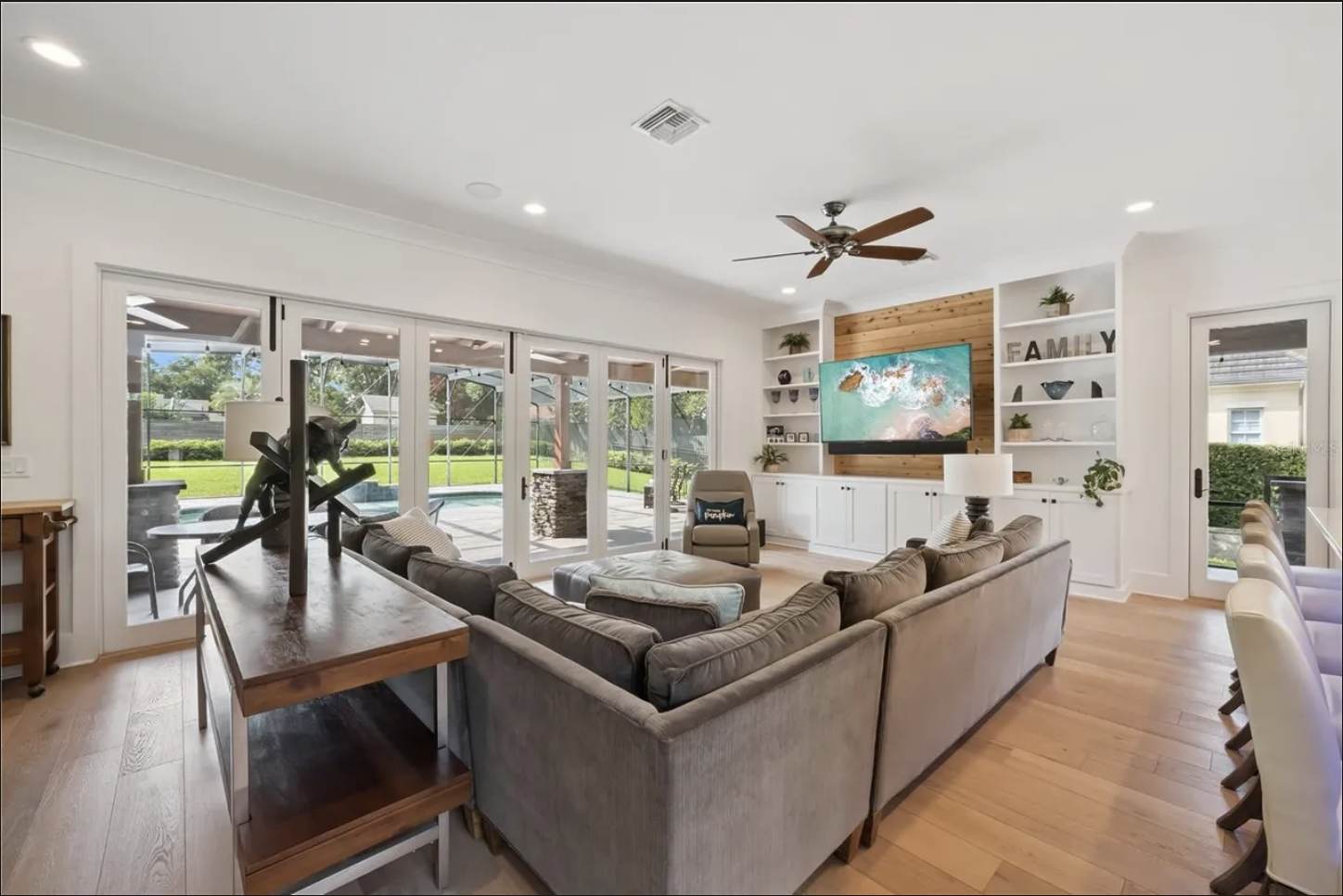 Family room with built-ins and sliding doors to the pool