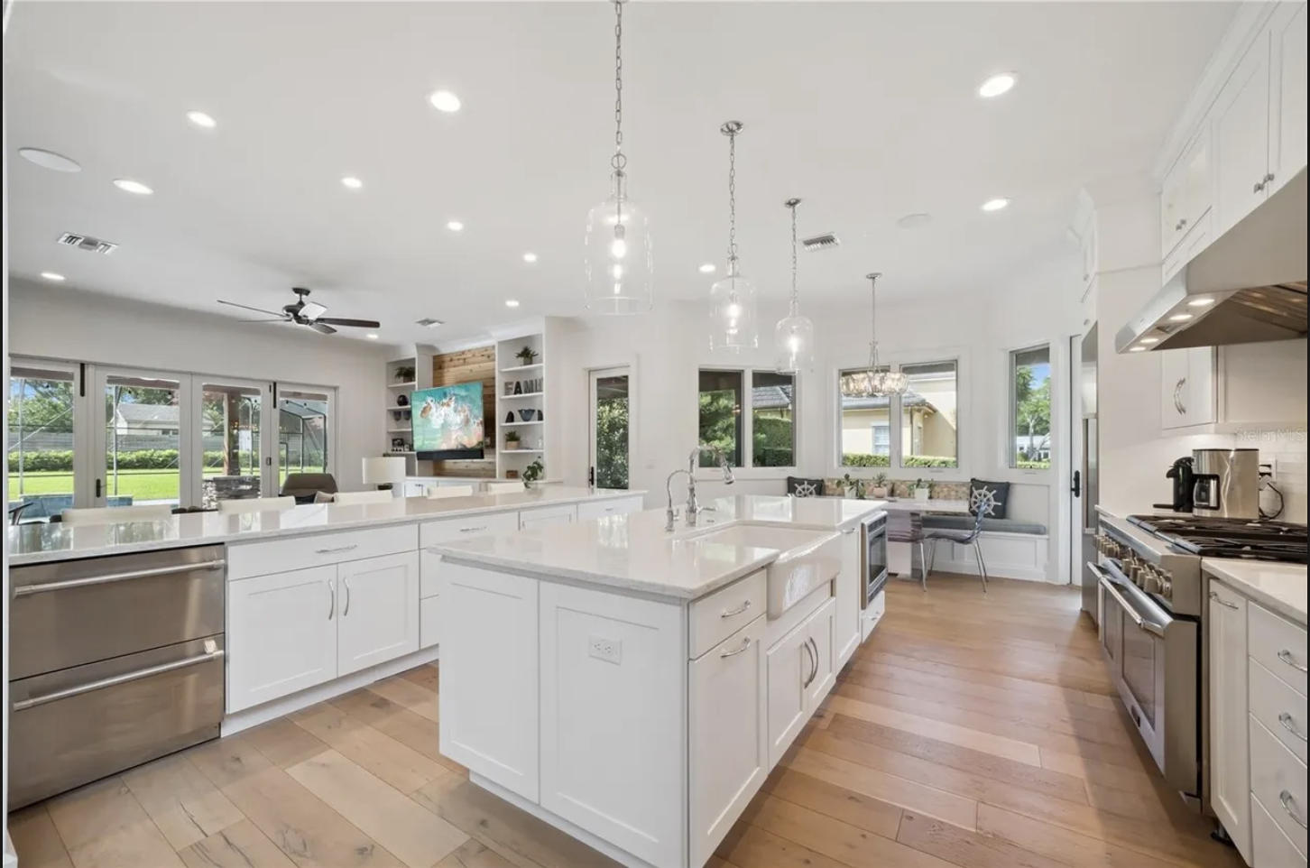 Kitchen with central island, white cabinetry, and breakfast nook