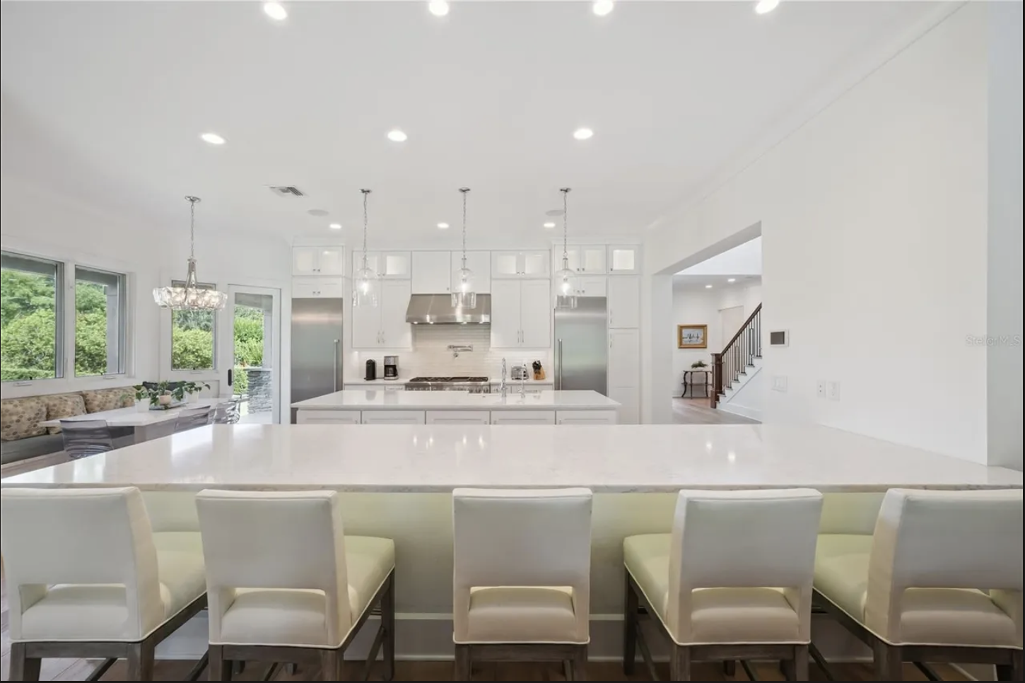 Kitchen with large quartz island and seating for six