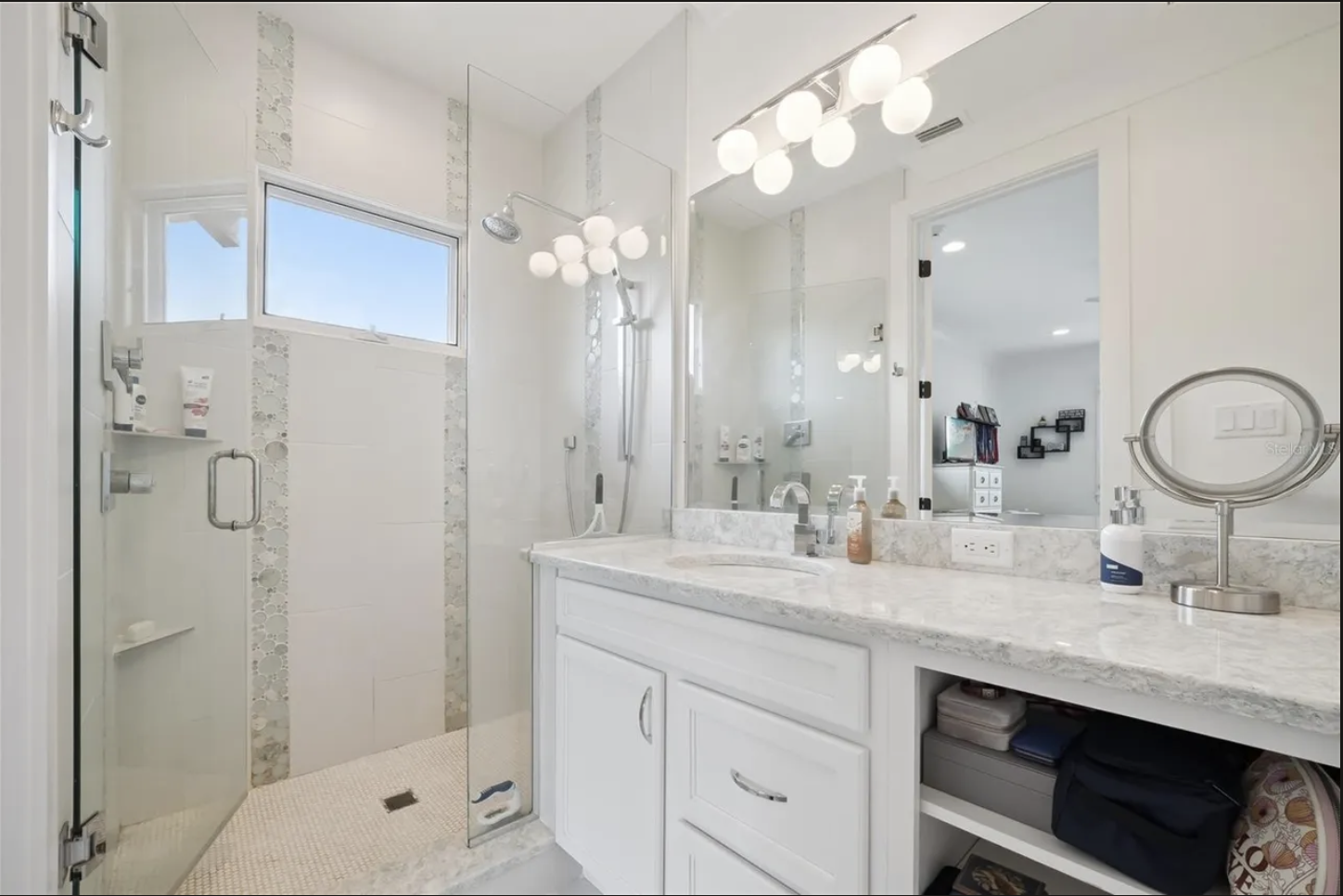 Guest bath with glass walk-in shower and marble-look vanity