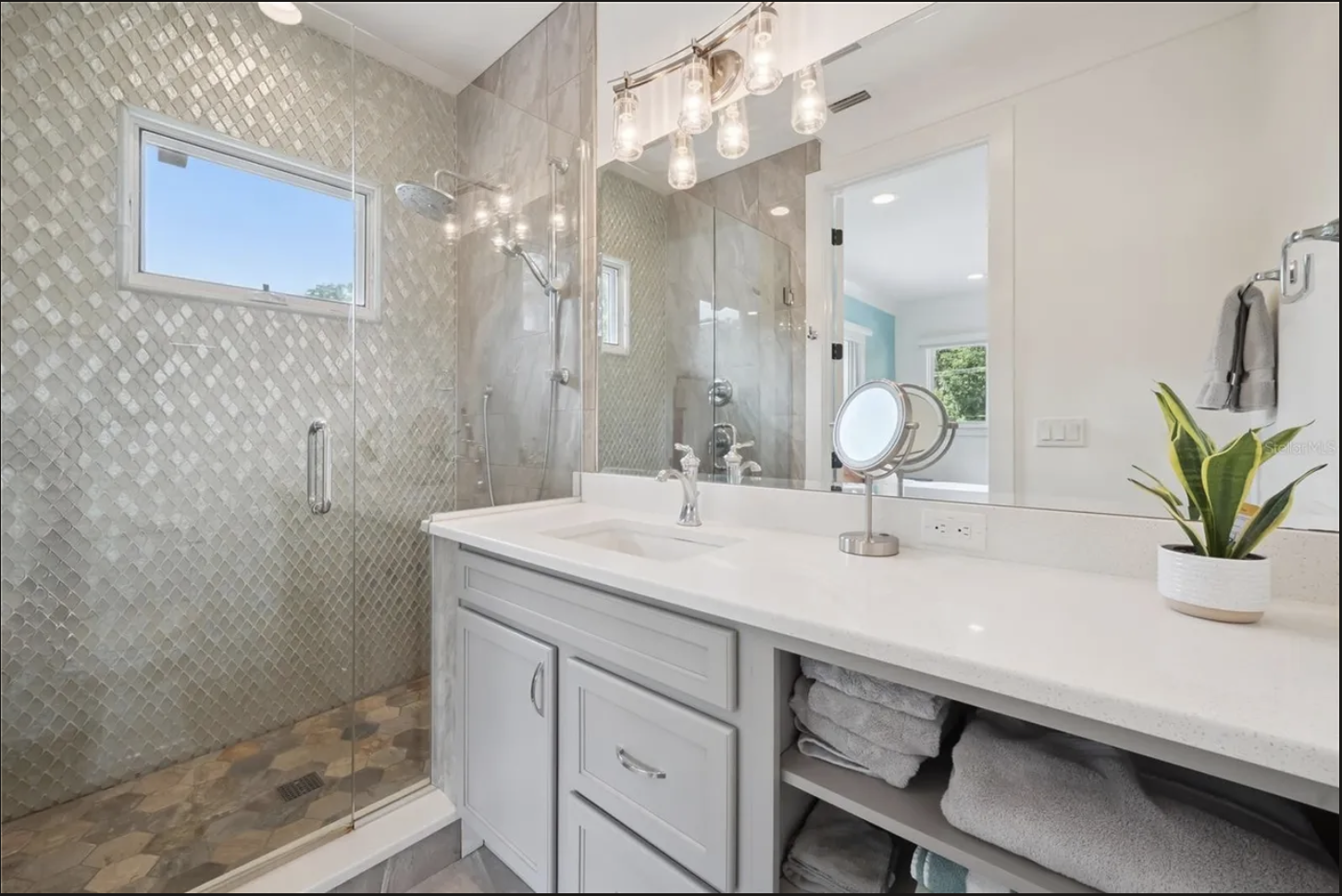 Bath with mosaic-tiled shower and quartz vanity