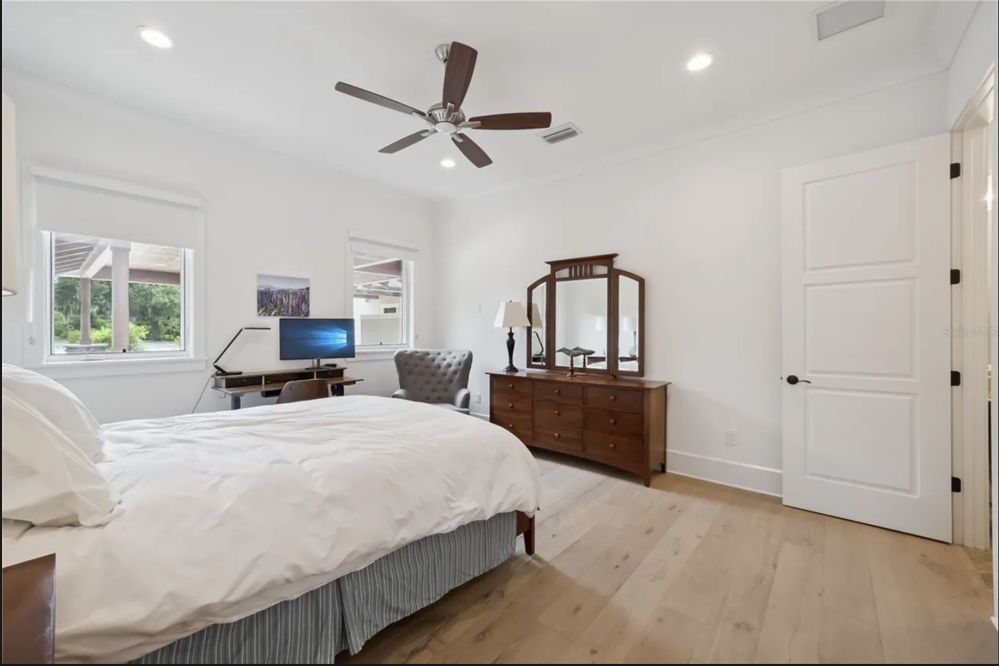 Bedroom with ceiling fan and natural light